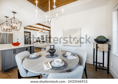 Dining room interior with table and chairs table settings staged with dinnerware flowers large windows bright and spacious home interior photography