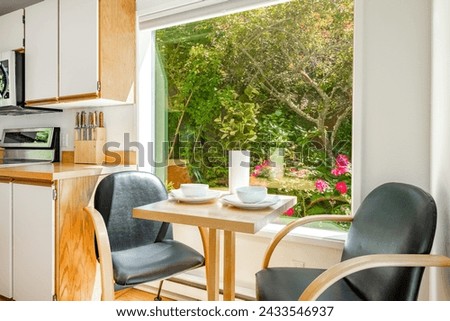 Dining room interior with table and chairs table settings staged with dinnerware flowers large windows bright and spacious home interior photography