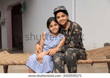 Indian army woman with her daughter at home