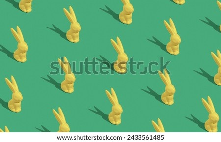 Creative Pattern composition of yellow Easter bunnies on green background. Minimalist isometric concept.Creative art, minimal aesthetic look. Contemporary style