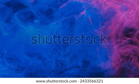 Glitter mist texture. Color smoke. Sea splash. Blue pink glowing shiny ink in water floating on dark abstract art free space background.