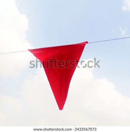 Parking lot decorated with flag rail.
(It's not red underwear!) Royalty-Free Stock Photo #2433567073