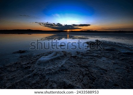 Beautiful sunset and blue sky and reflection of clouds and salty beach
