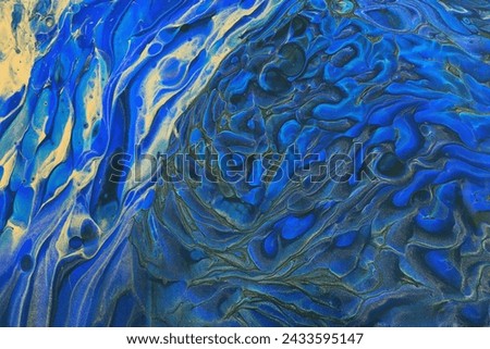 art photography of abstract marbleized effect background with blue and gold creative colors. Beautiful paint. Royalty-Free Stock Photo #2433595147