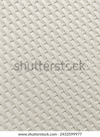 Close up white plastic chair or table furniture woven pattern texture isolated on vertical ratio background. Wallpaper and backdrop interior photography.