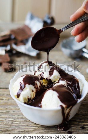 vanilla ice cream in a white bowl with chocolate Royalty-Free Stock Photo #243363406