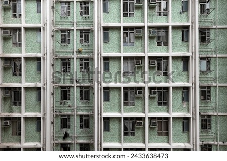 Exterior photo view of a building tower facade front with all th windows and air conditionned in Hong Kong suring the day in Asia in urban distrcit city area