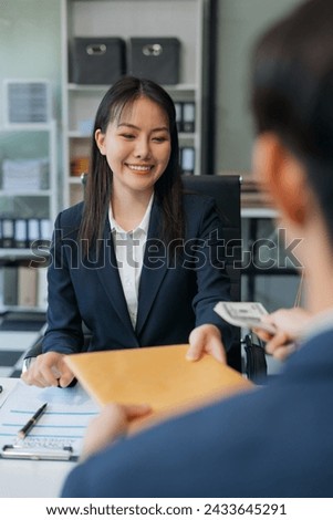 Business woman offer cost of hundred dollars. Hands close up Venality, bribes, fraud concept hand give money - United States dollars, hand get paid by businessman. Royalty-Free Stock Photo #2433645291
