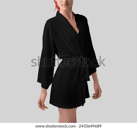 Mockup of black silk robe on athletic redhead girl, side view, kimono with belt on waist. Stylish home apparel template isolated on background. Slim woman in a dressing gown, for design, branding. Royalty-Free Stock Photo #2433649689