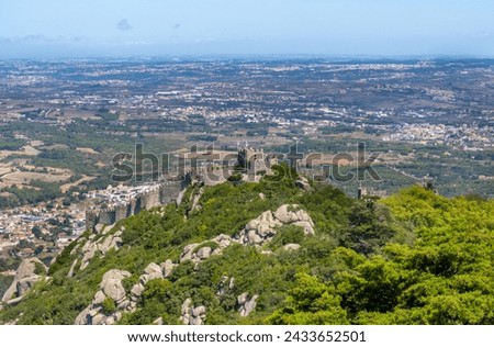 Panoramic aerial view from the Pena Palace of the Arab castle, built by the Moors, taken by the Vikings and conquered by the King of Portugal. In Sintra, Portugal. Castelo dos Mouros Royalty-Free Stock Photo #2433652501