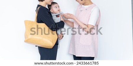 A mother and a childcare worker who leave their child at a nursery school Royalty-Free Stock Photo #2433661785