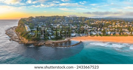 Scenic sunrise seascape with clouds and fog at Avoca Beach on the Central Coast, NSW, Australia. Royalty-Free Stock Photo #2433667523