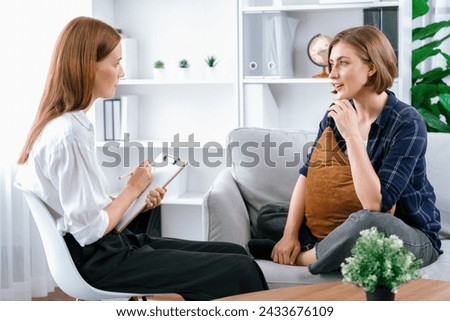 Happy patient and psychologist have mental health conversation in clinic with positive emotion while explaining utmost successful work and life to psychologist in home office . Royalty-Free Stock Photo #2433676109
