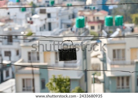 Indian junction box connecting long wires of outdoor wiring system on low rise Indian buildings background, unreliable old wiring without insulation urging for necessary upgrades Royalty-Free Stock Photo #2433680935