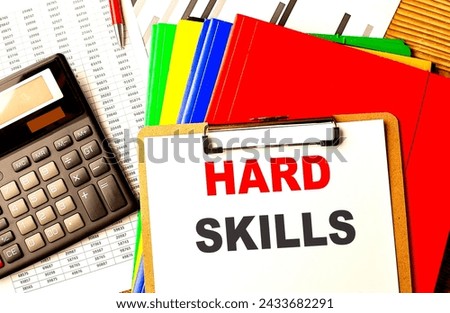 HARD SKILLS. text written on a paper clipboard with chart and calculator