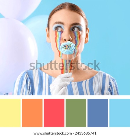 Young woman with painted rainbow on her face and candy against blue background. Different color patterns
