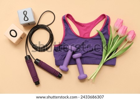 Composition with sports equipment, bra and tulip flowers on color background. International Women's Day Royalty-Free Stock Photo #2433686307