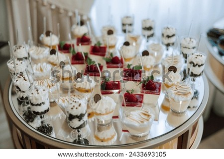 Almond cookies, sweet cakes for a wedding banquet. A delicious reception, a luxurious ceremony. Table with sweets and desserts. Delicious colorful French desserts on a plate or table. Candy bar.