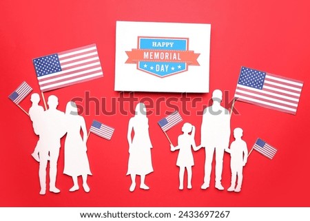 Greeting card with text HAPPY MEMORIAL DAY, family figures and USA flags on red background