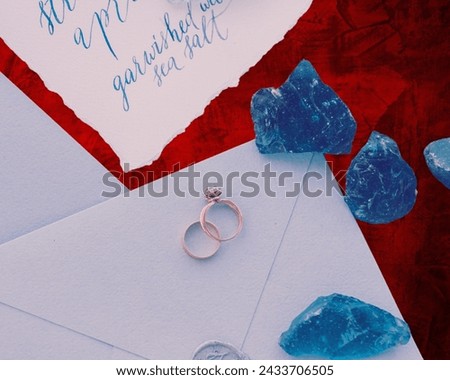 The image shows a group of gold rings with colorful background 
       wedding rings