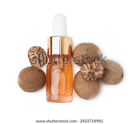 Nutmeg essential oil and nuts isolated on white, top view