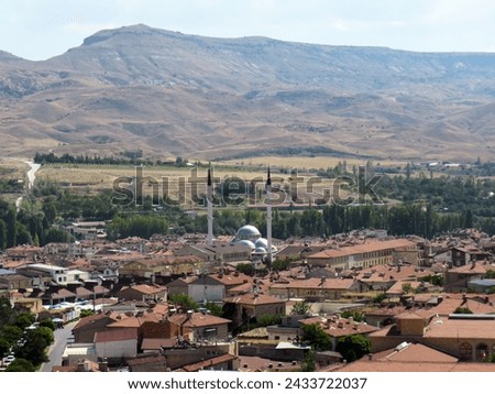 Urgup. View of the mountains from above. Mosque in the city center. Mountains and city. Royalty-Free Stock Photo #2433722037