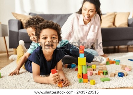 focus on jolly african american boy smiling at camera with his blurred mom and brother on backdrop