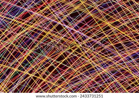 Chaos texture. Neon lights background. Motion lines texture. Long exposure moving light pattern. Abstract night life background. Glowing lines design. Colorful illumination.