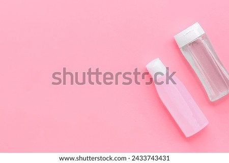 skin care organic cosmetics with facial tonic bottle, mycelial water bottle on pink desk background top view mockup Royalty-Free Stock Photo #2433743431