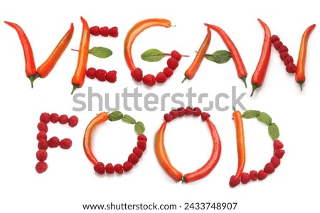 letters V E G A N F O O D from orange red chili peppers, red berry and green salad lettuce leaf, homemade meal, home made vegan food dinner, raspberries salad with raspberry vinegar present voucher Royalty-Free Stock Photo #2433748907