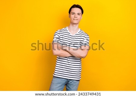 Portrait of handsome student with brunet hair wear stylish t-shirt holding palms folded isolated on bright yellow color background