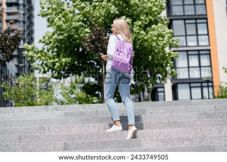 Photo of adorable pretty good mood girl going to university lectures september day outdoors