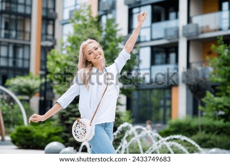 Photo of positive cute shiny millennial girl spending free time after work in park enjoying spring weather Royalty-Free Stock Photo #2433749683
