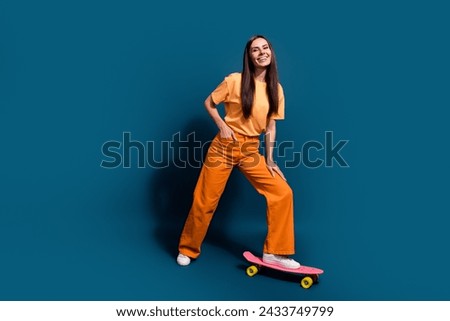 Full body size photo of happy smiling brunette hair lady ride longboard enjoy her hobby make tricks isolated on dark blue color background