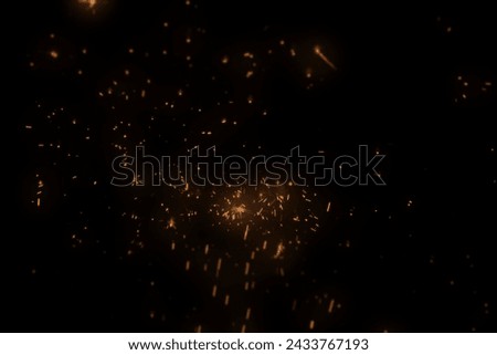 Black Background Stock Image Featuring Luminous Particles, Abstract Festive Christmas Texture with Golden Bokeh Particles and Highlights. High-resolution Photograph.