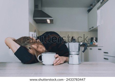 Tired sleepy person female having some problems. Exhausted woman with coffee at home. Сoncept of woman or mother in depression, burnt out, tired from work or study, unsatisfactory with her life. Royalty-Free Stock Photo #2433783447