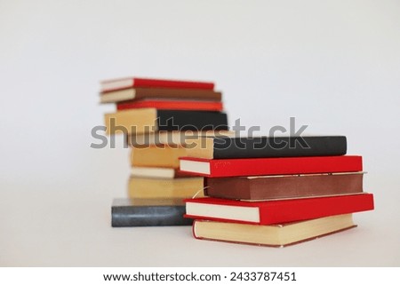 stack of books in the shape of a pyramid on a white background