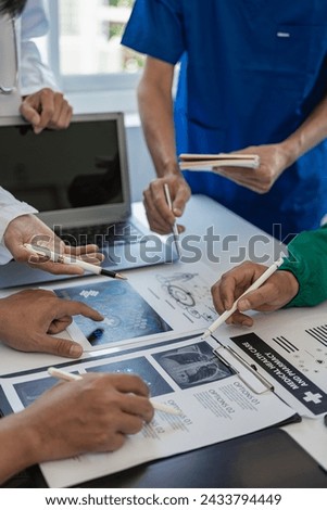 Meetings and laptops for office teams to discuss brainstorming and planning. Doctors, nurses, and computers on desks demonstrate the diversity of collaboration. Close-up pictures Royalty-Free Stock Photo #2433794449