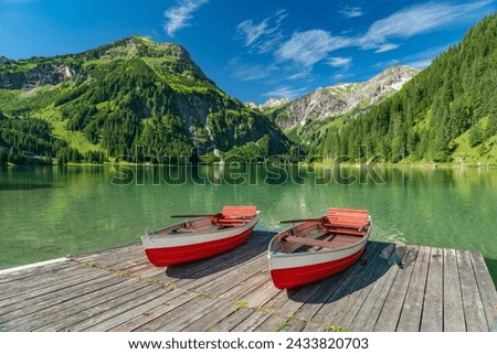 etty with rowing boats on the beautiful Vilsalpsee in the Tannheimer Valley with the Allgaeu Alps, Tyrol Austria Royalty-Free Stock Photo #2433820703