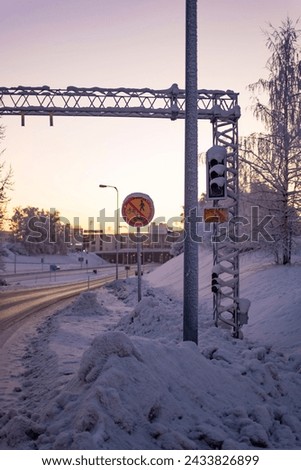 Highway entrance traffic signal covered in snow on a winter scene in Rovaniemi, Finnish Lapland