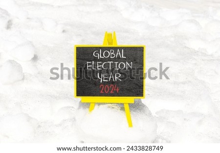 Global election year 2024 symbol. Concept words Global election year 2024 on beautiful black chalk blackboard. Beautiful white snow background. Business Global election year 2024 concept. Copy space