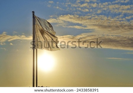 Argentine flag flying at sunset Royalty-Free Stock Photo #2433858391