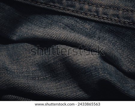 Dark jeans texture at night for a super cool fashion background.  Royalty-Free Stock Photo #2433865563