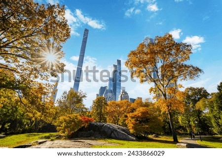 Central Park fall daytime with the Manhattan skyline in the background with sun rays. Royalty-Free Stock Photo #2433866029