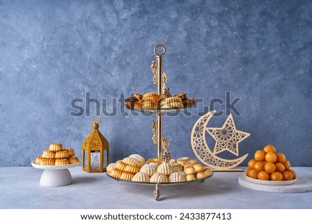 Assorted semolina maamoul or mamoul cookies , awameh or lokma with ramadan decor crescent moon. Traditional arabic Eid al Adha, Eid al Fitr , Ramadan sweets Royalty-Free Stock Photo #2433877413