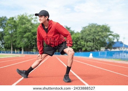 Young cool Asian men in sportswear stretching in sports fields in various poses in bright sunny morning to maintain health and healthy lifestyle. morning exercise healthy and active living concept