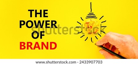 The power of brand symbol. Concept words The power of brand on beautiful yellow paper. Beautiful yellow background. Light bulb icon. Businessman hand. Business the power of brand concept. Copy space.