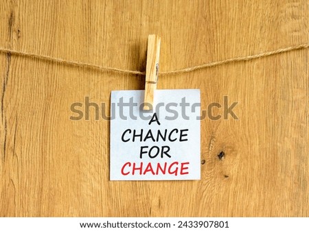 A chance for change symbol. Concept words A chance for change on beautiful white paper on clothespin. Beautiful wooden background. Business A chance for change concept. Copy space.