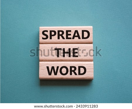 Spread the Word symbol. Concept words Spread the Word on wooden blocks. Beautiful grey green background. Business and Spread the Word concept. Copy space.