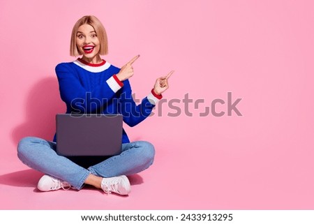 Full body photo of woman blue sweater direct forefingers empty space laptop surprised winter steam sale isolated on pink color background
